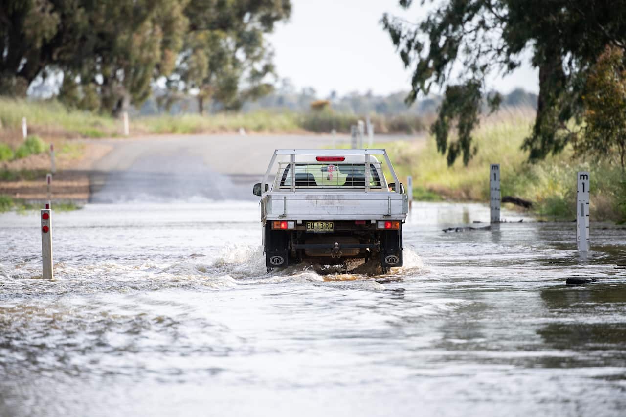 A vehicle negotiates floodwater south of Forbes, NSW.