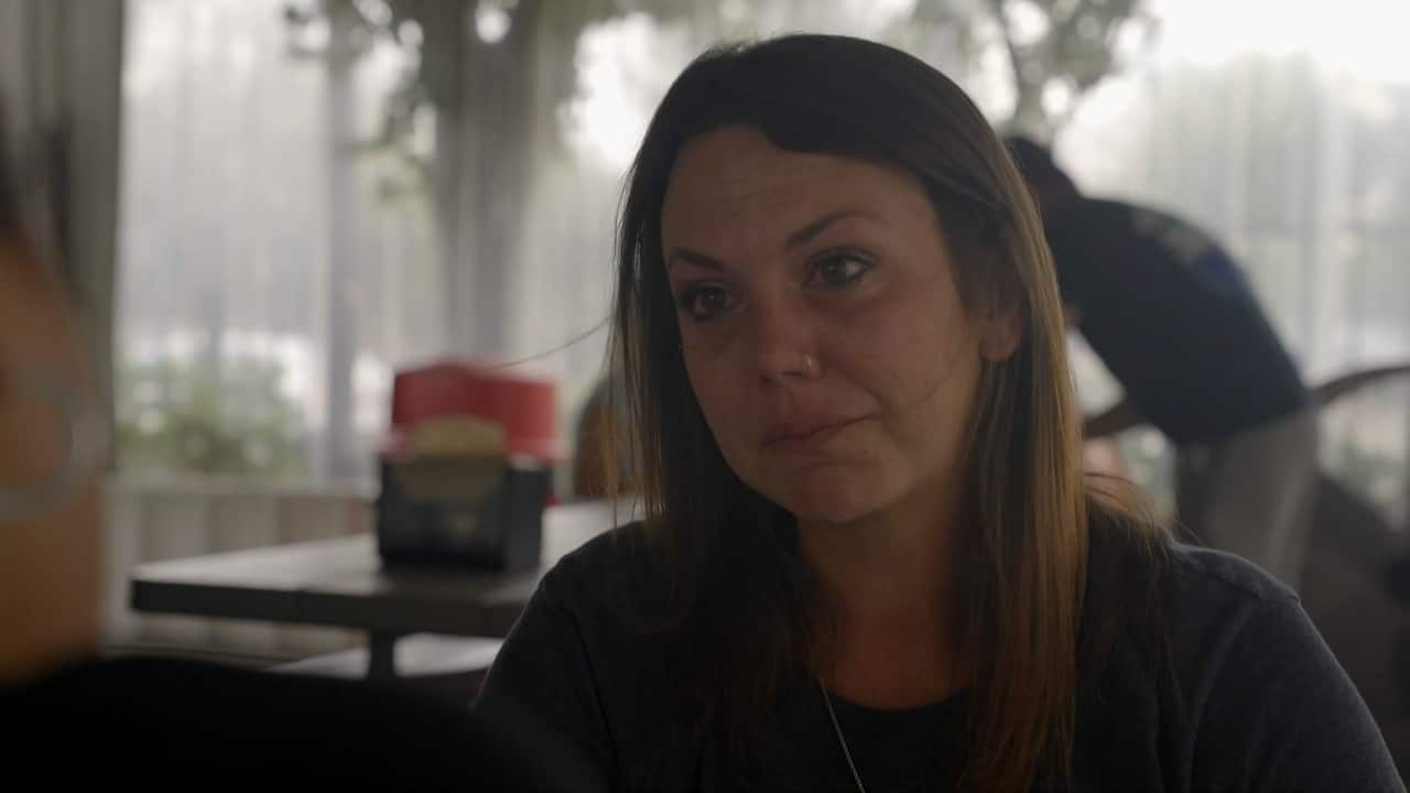 A woman with brown hair.