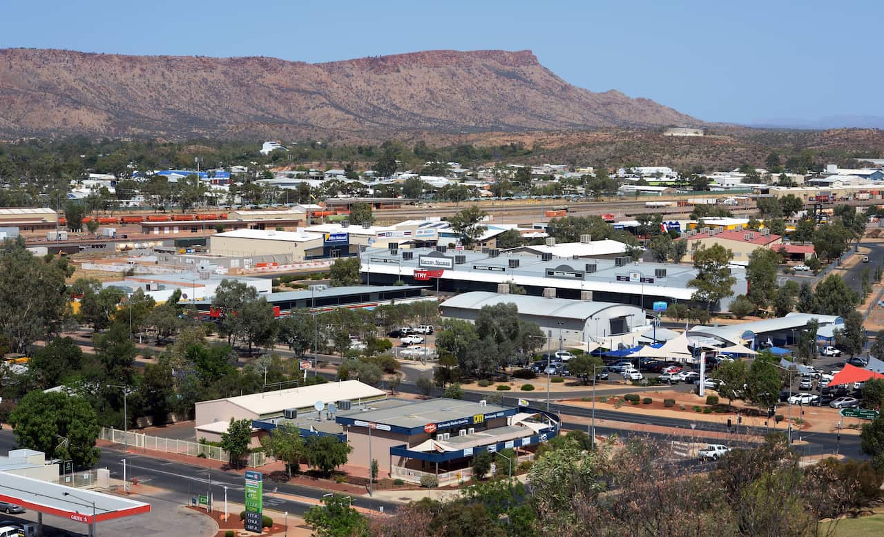 An aerial view of a town surrounded by large hills.