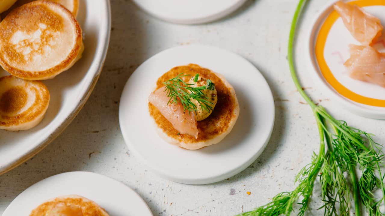 Blinis with turmeric cream, salmon and dill