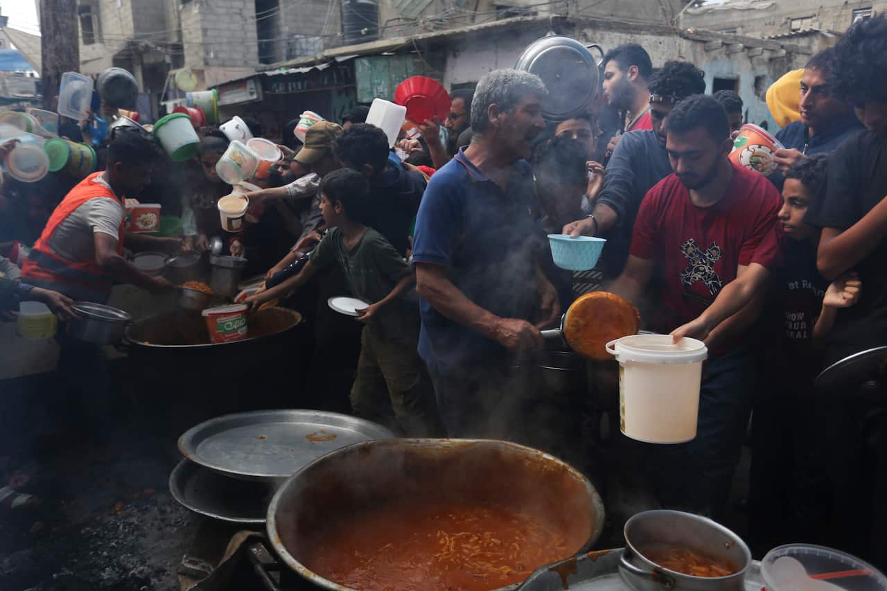 People queue up for food.