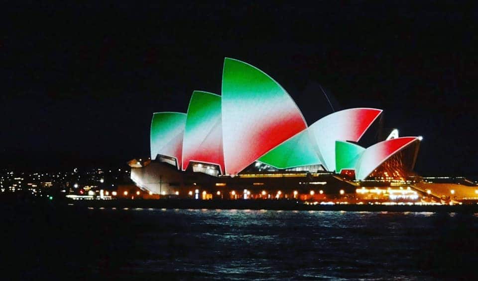 The sails of the Opera House illuminated with the colors of the Italian flag on 2 June 2021