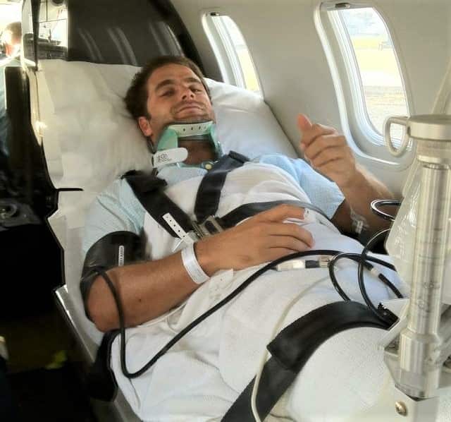 Tom Caska in a helicopter after his accident .