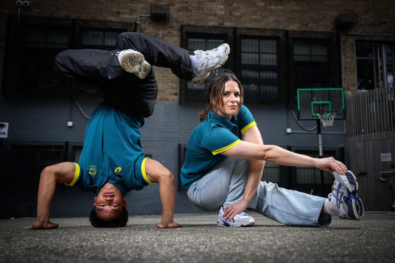 Two athletes pose in breakdance poses