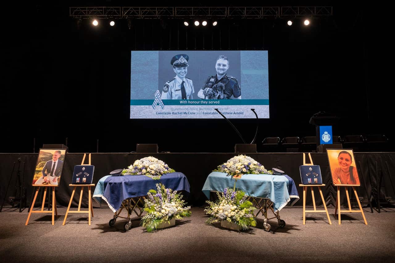 Two caskets in front of a projector. 
