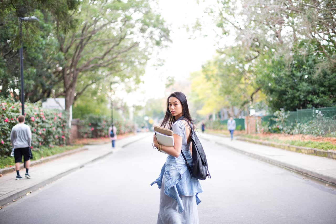University college student on walking with books