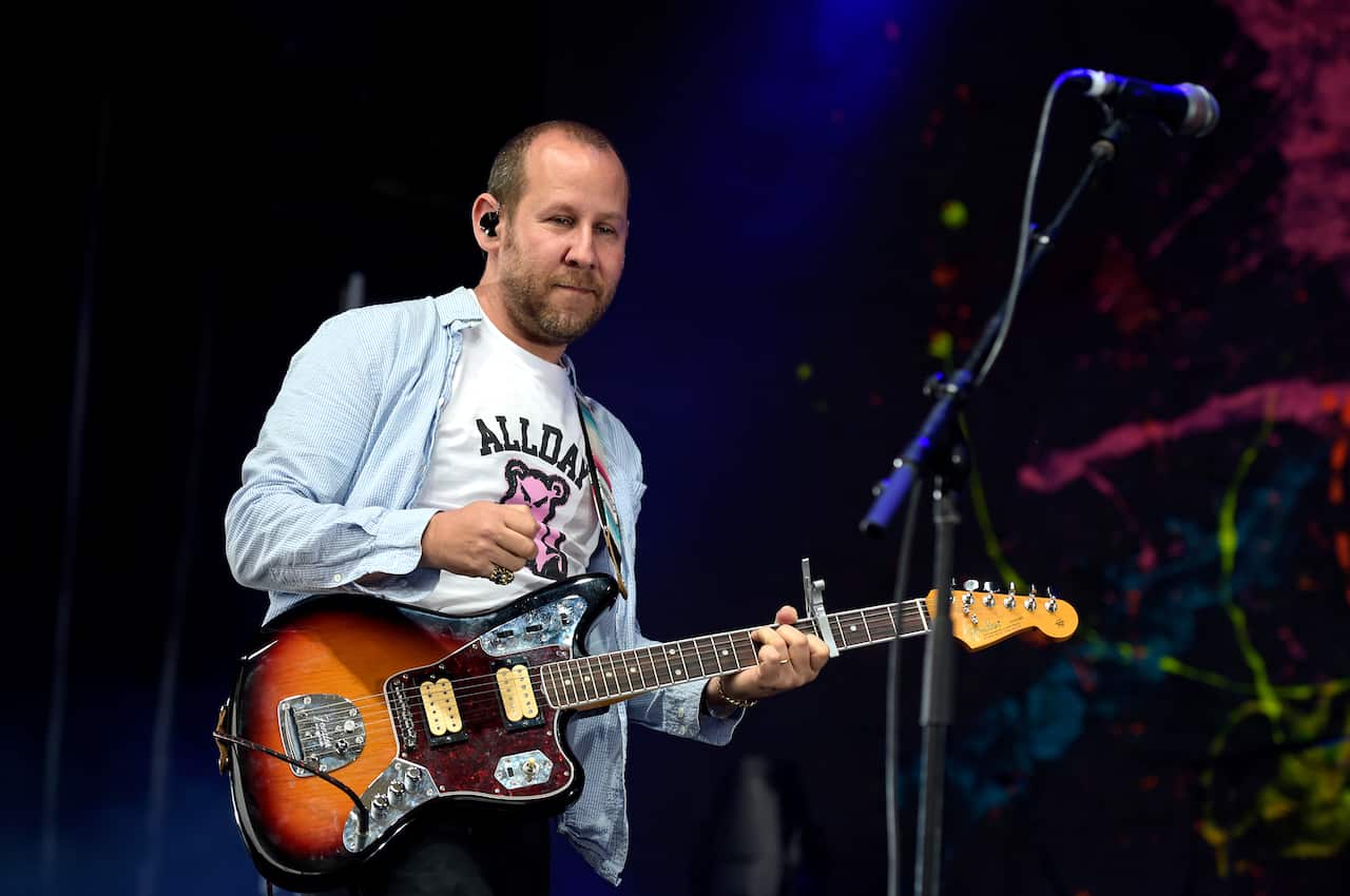 A man playing guitar on stage.