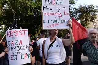People hold up signs at a demonstration