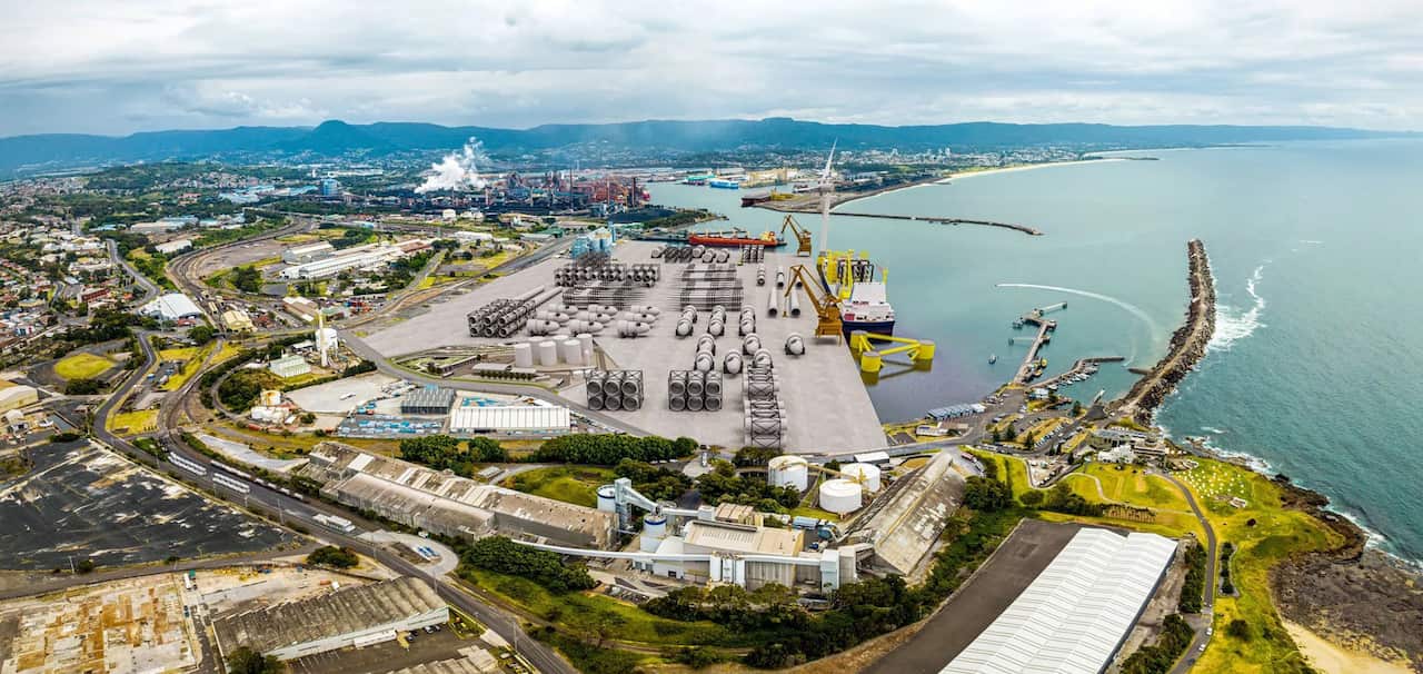 An aerial shot of a steelworks next to the ocean