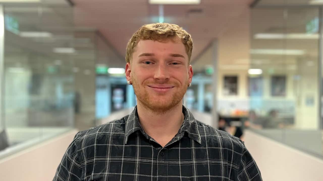 a closeup of a young ginger boy in a hallway