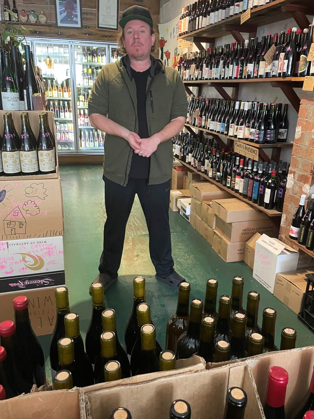 Mike Bennie standing in his Newtown wine store