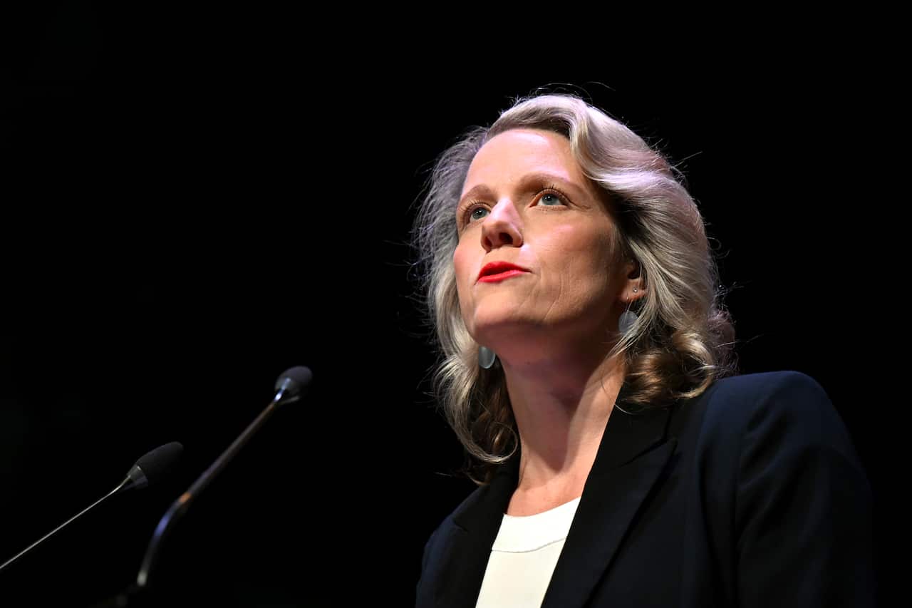 Clare O'Neil speaking into a microphone