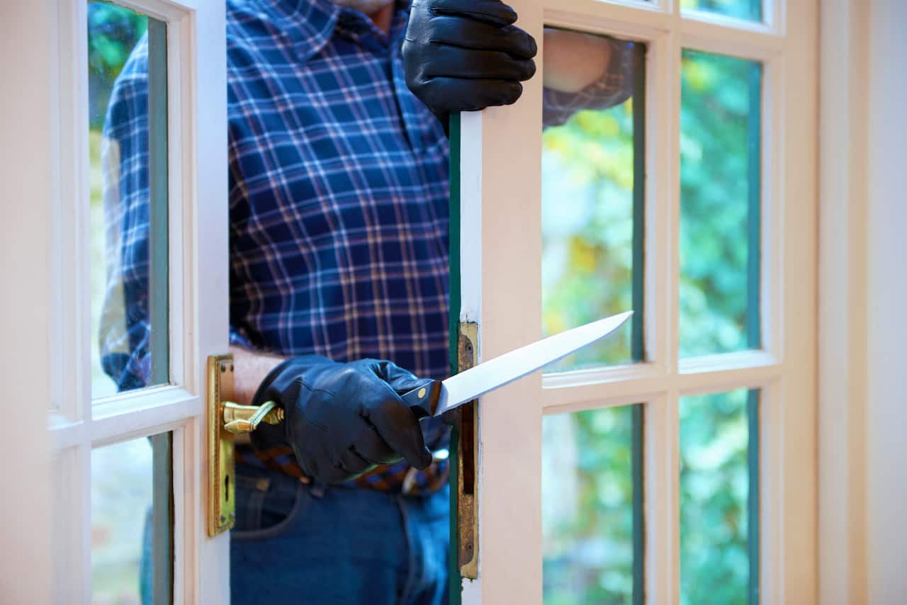 Burglar entering with knife