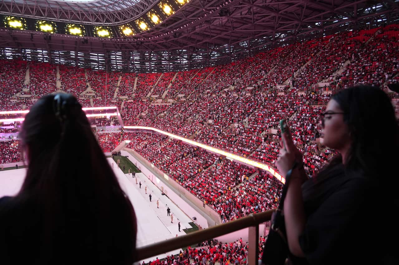 Thousands of Moroccan football fans wearing red in a stadium