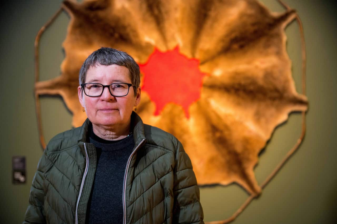 A woman standing in front of a wall display
