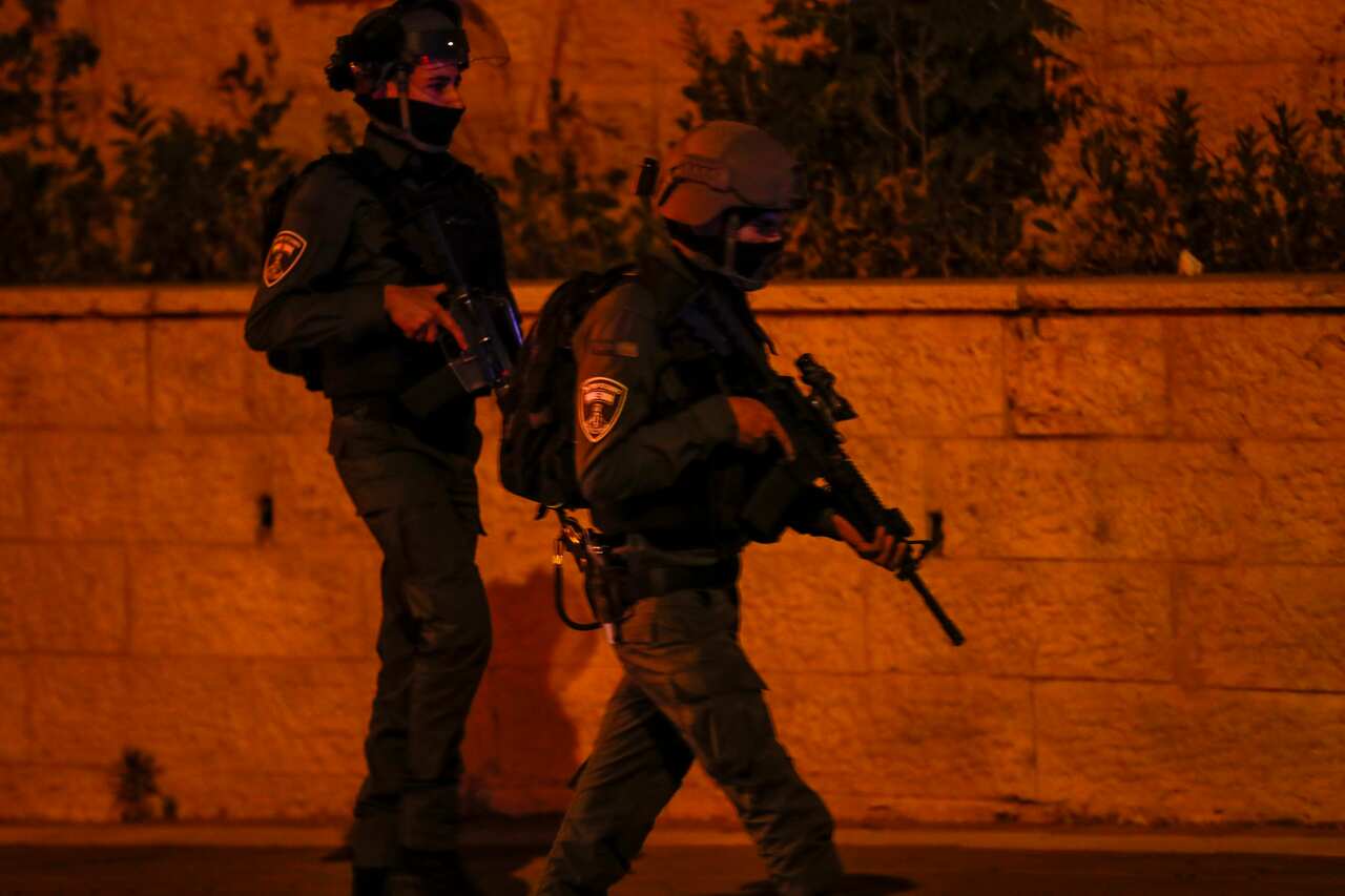 Two police officers holding guns.