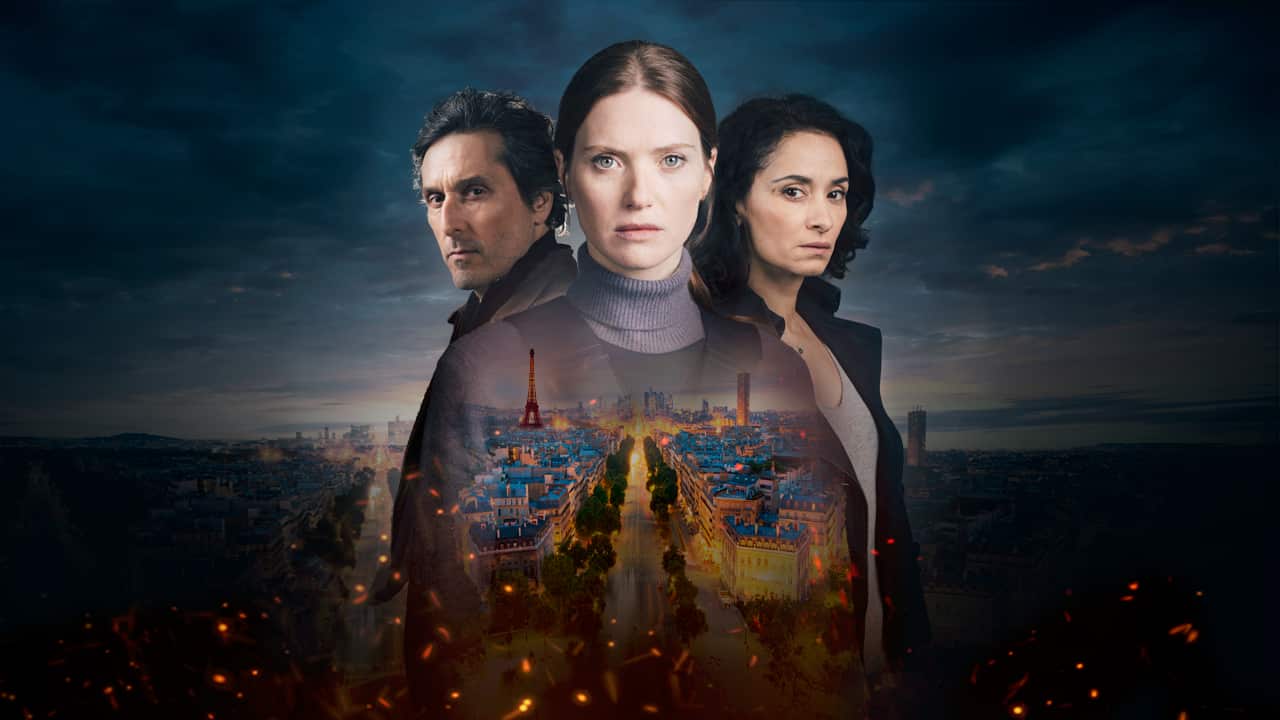 Two women and a man stand above the skyline of Paris