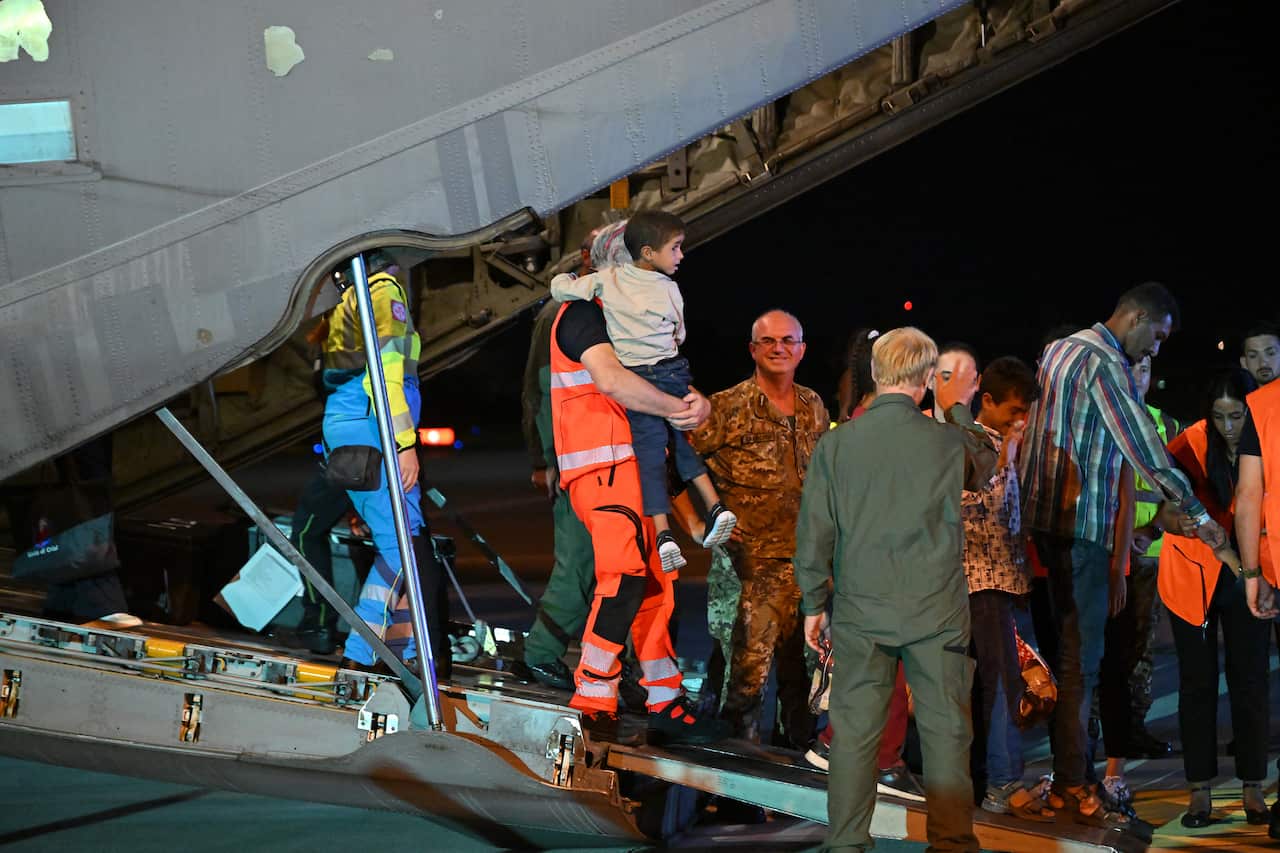 Medics and health personnel welcome Palestinian children from Gaza and their families