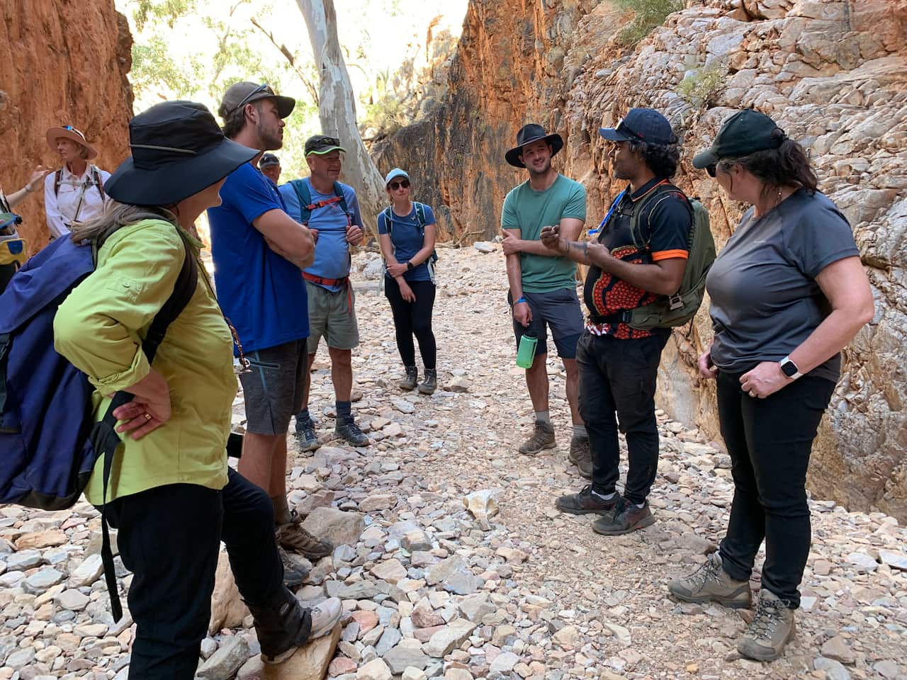 Visitors listen to an Aborigial tour guide in the chasm