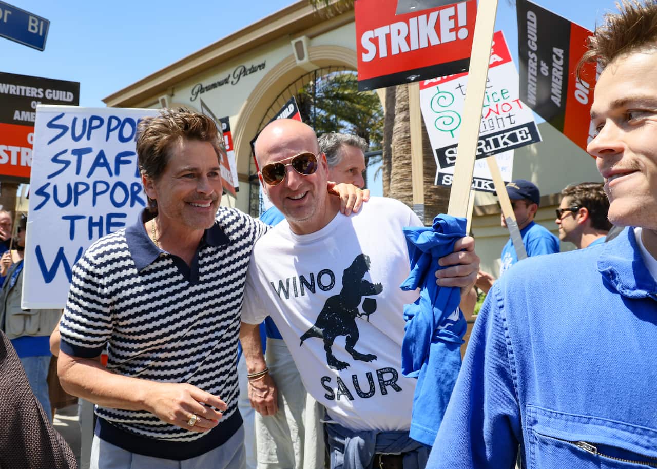 A group of people holding placards in front of the Paramoutn Pictures building in Los Angeles.