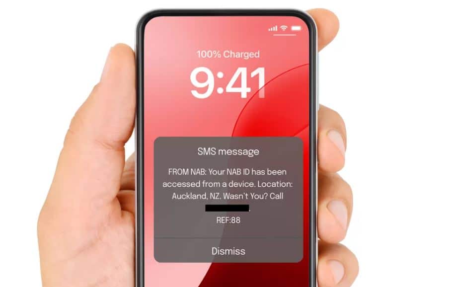 A screen shot of a hand holding a phone with an SMS message being desplayed.
