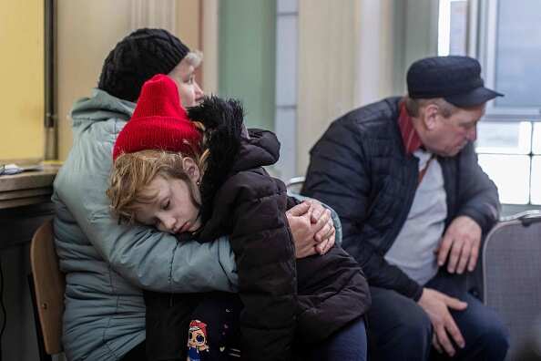 A little girl from Lviv named Katia is seen sleeping in her grandmother Luba's arms at the railway station in Przemysl, southeastern Poland, on 3 April 2022.