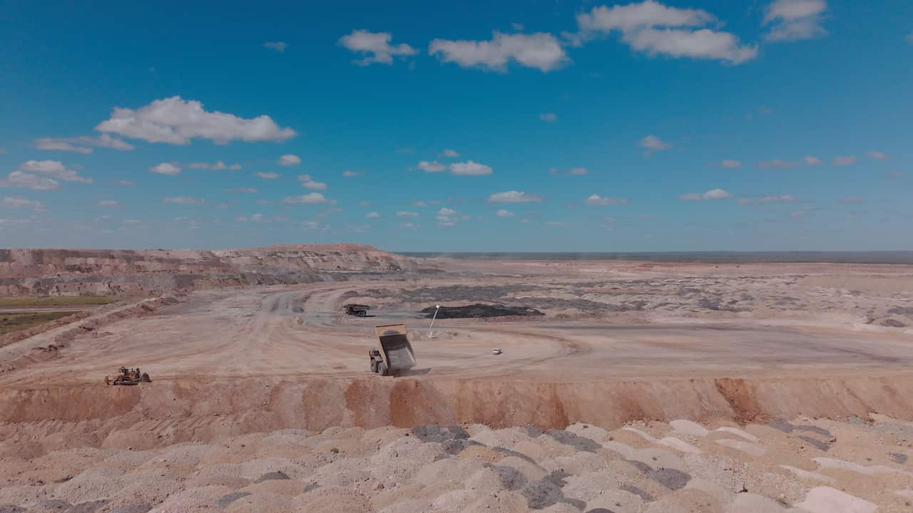 A drone shot of overburden piles at a coal mine, showing large piles of dirt removed from mine sites.