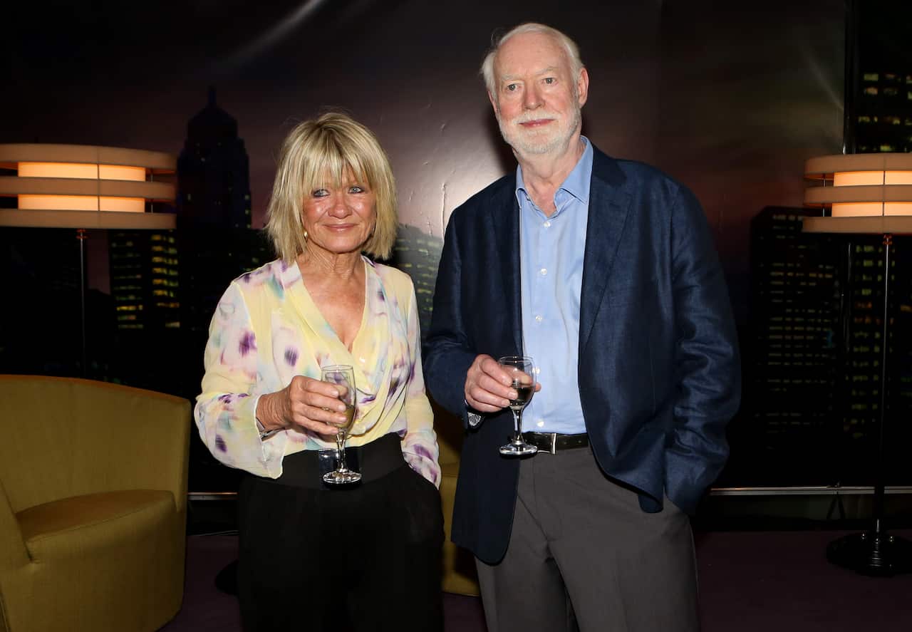 Margaret Pomeranz and David Stratton standing near each other, each holding a glass.