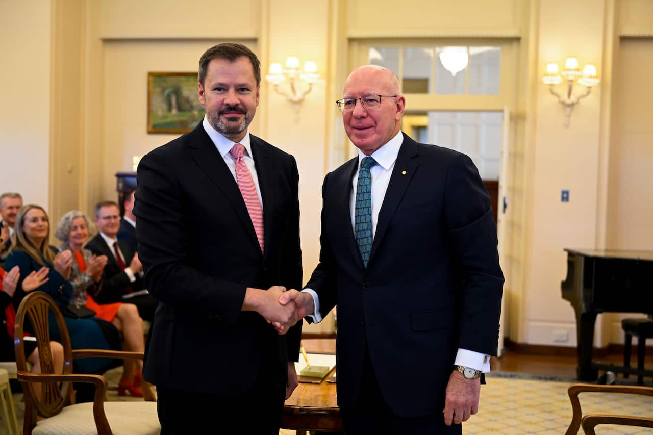 Industry and Science Minister Ed Husic shakes hands with Governor-General David Hurley.