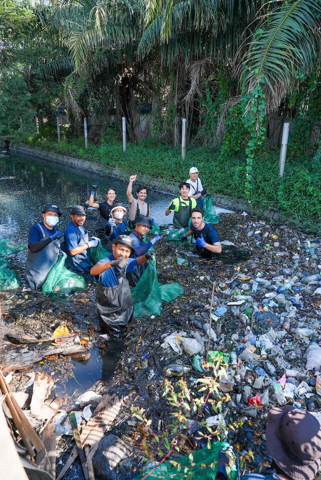 The Sungai Watch team pulls rubbish from a river during a stop on the 1,200-kilometre Bali-to-Jakarta run.