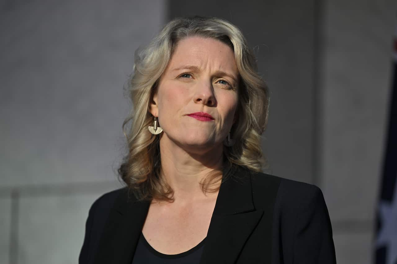 Woman in black blazer.