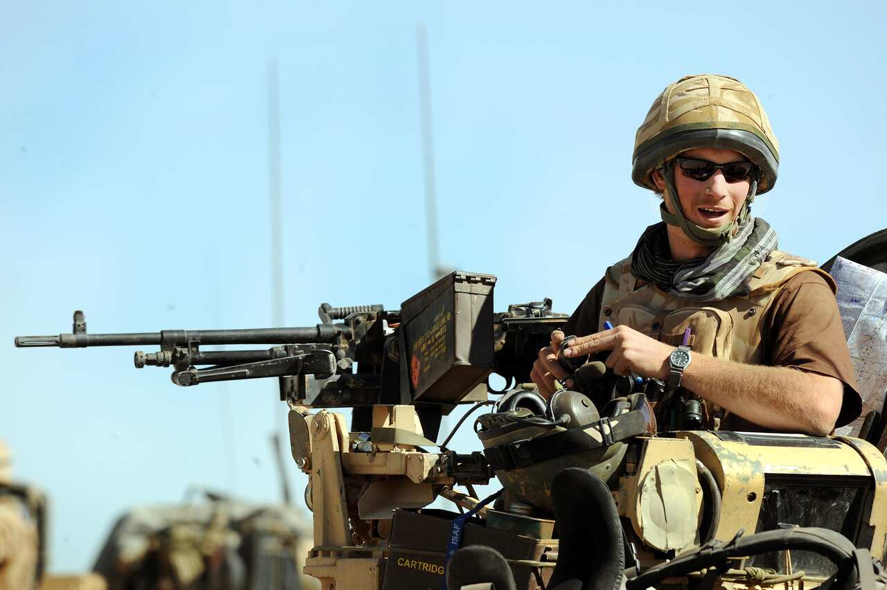 A man sitting on an armoured vehicle.