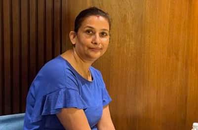 A woman in a blue top.