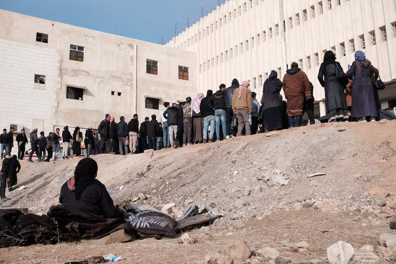People standing outside a large building