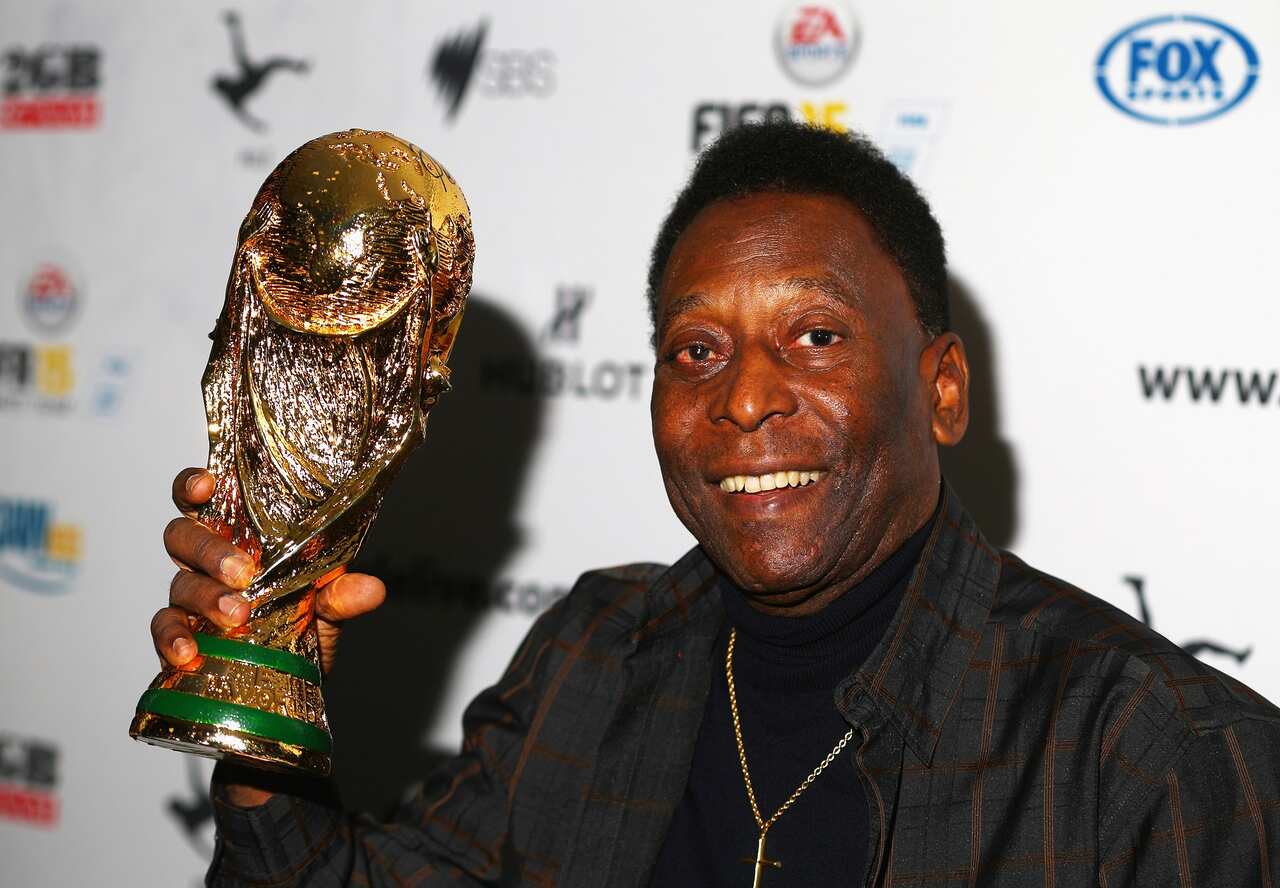 Pele holds a replica World Cup trophy during a press conference in Melbourne on 26 March 2015. 
