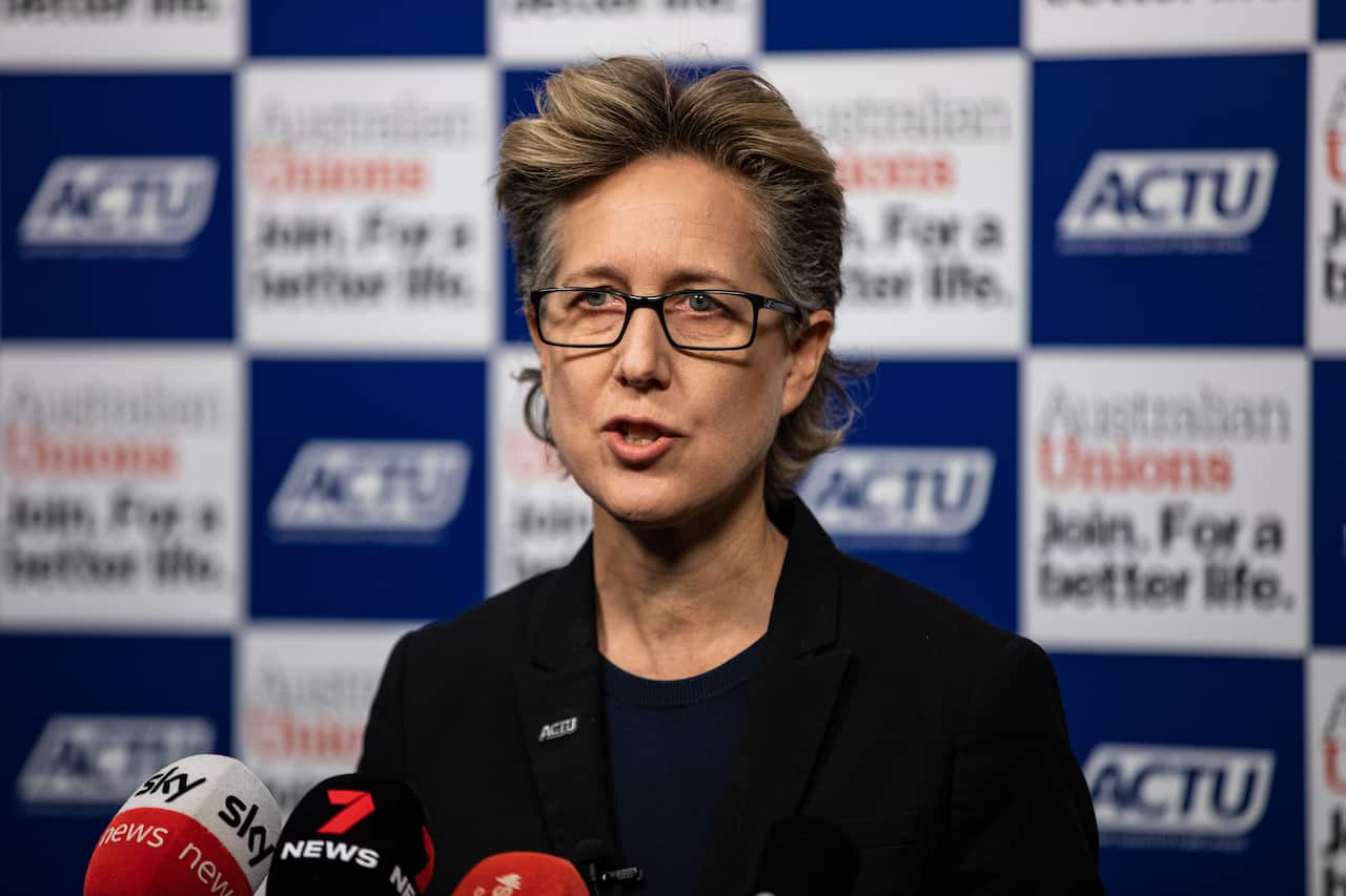 Sally McManus speaking into a microphone