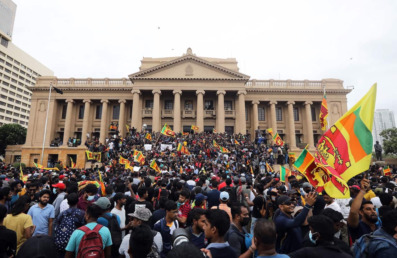 Thousands of protesters entered the capital Colombo and swarmed into Mr Rajapaksa's fortified residence.