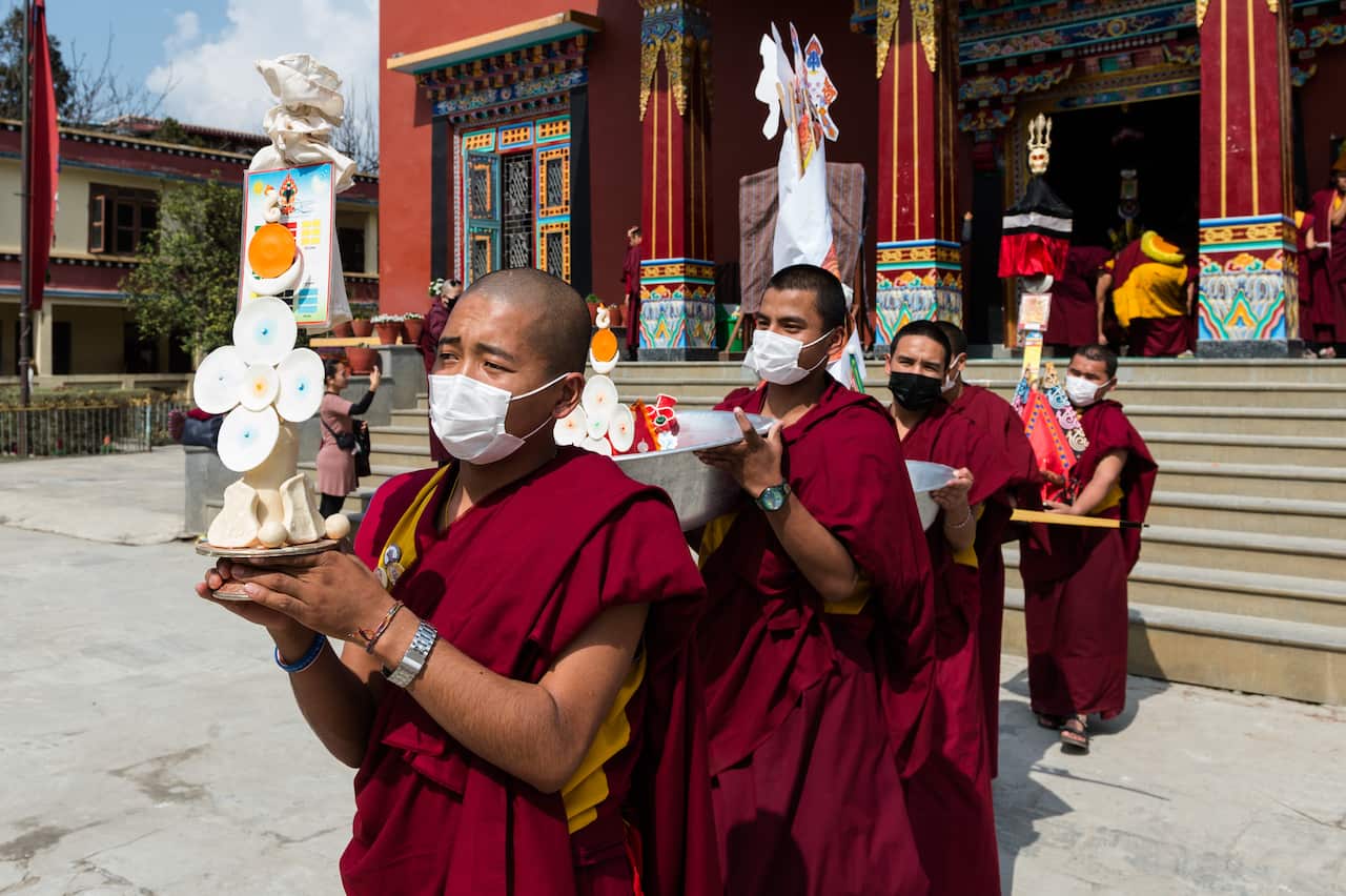 Tibetan monks carry trays with torma offerings during the spiritual cham dance at the Shechen Monastery in Boudhanath as part of the Losar, Tibetan New Year, celebrations on 22 February, 2020 in Kathmandu, Nepal. The ritual cham dance performed ahead of the New Year symbolises removing obstacles and negative energy.