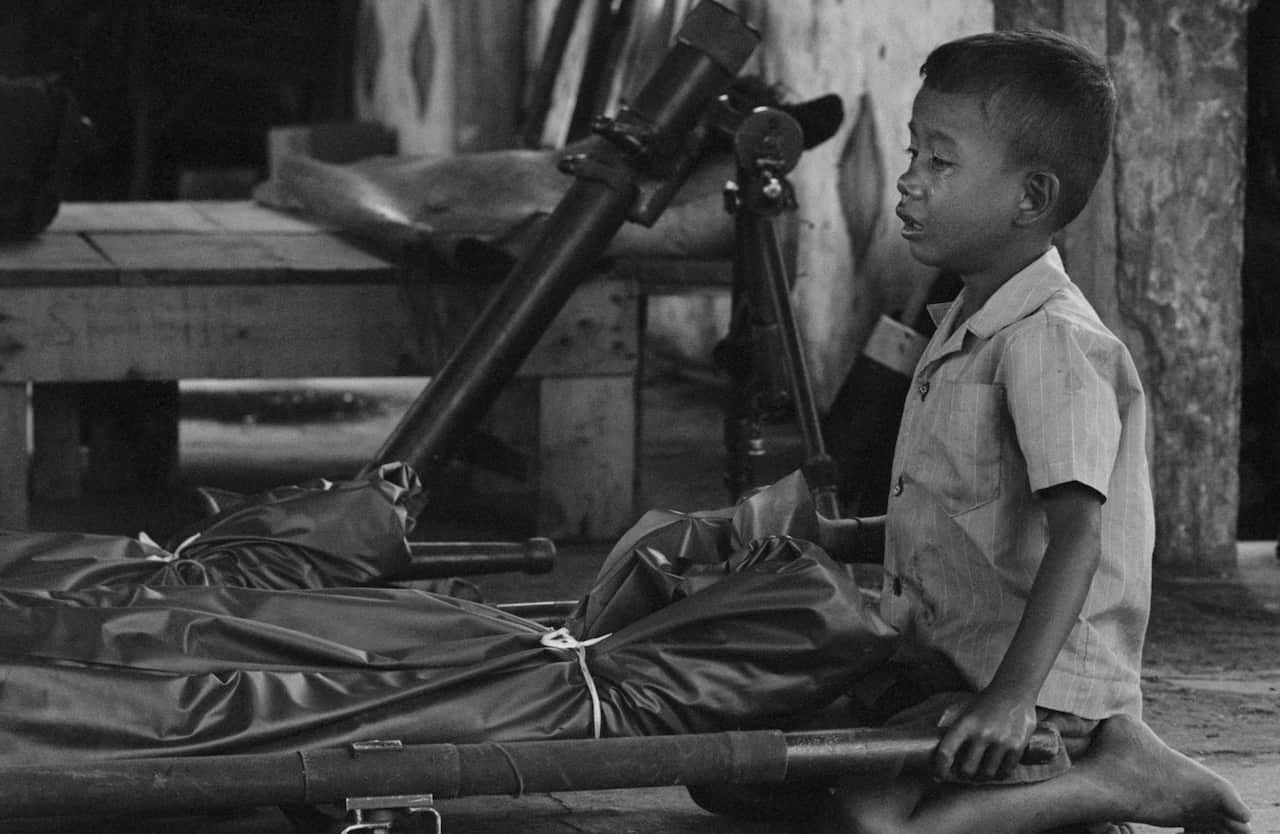 Cambodian Child Crying Next to His Father's Body