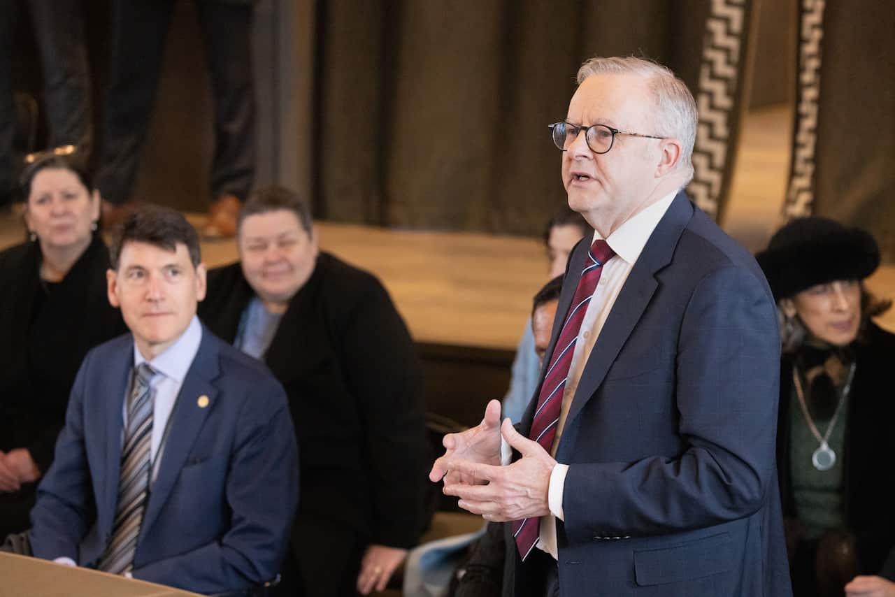 Anthony Albanese standing to speak to a group of people while in new Zealand.