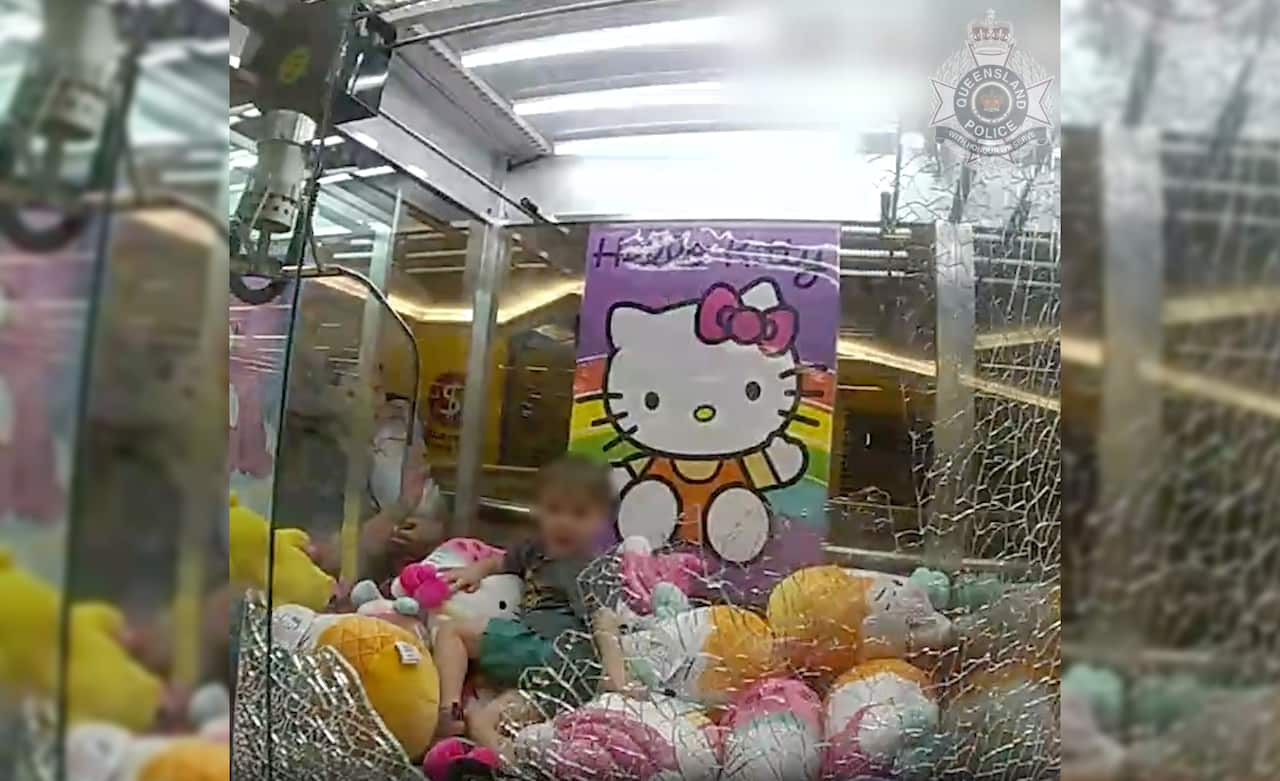 A police photo showing a child in a Hello Kitty skills tester machine