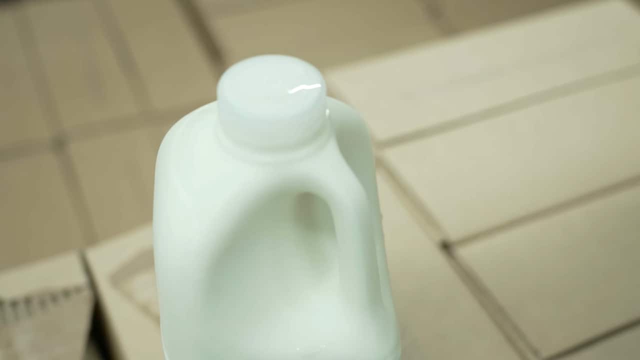 A two litre bottle of milk with a clear cap