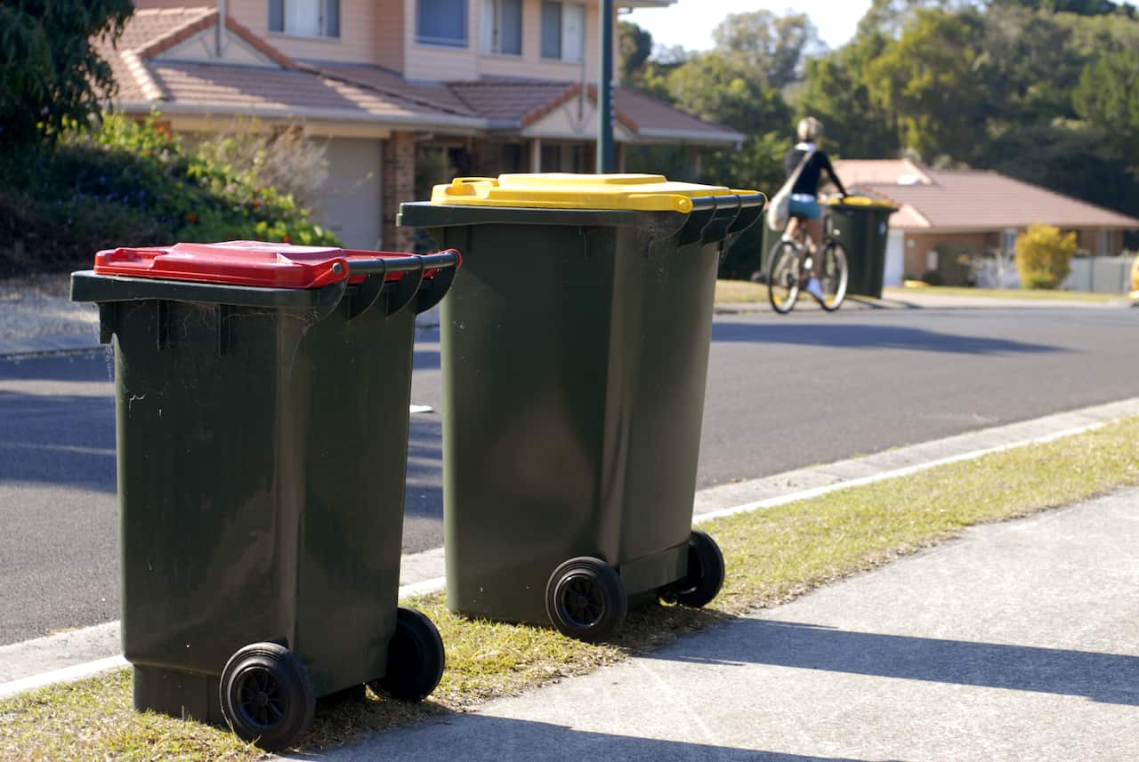 Two Australian rubbish bins Red is rubbish, yellow is recycling