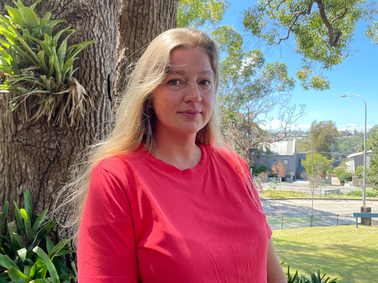 A woman wearing a pink shirt.