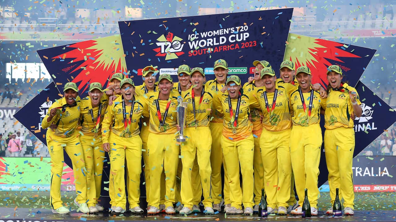 Australia's women's cricket team celebrating with trophy and medals