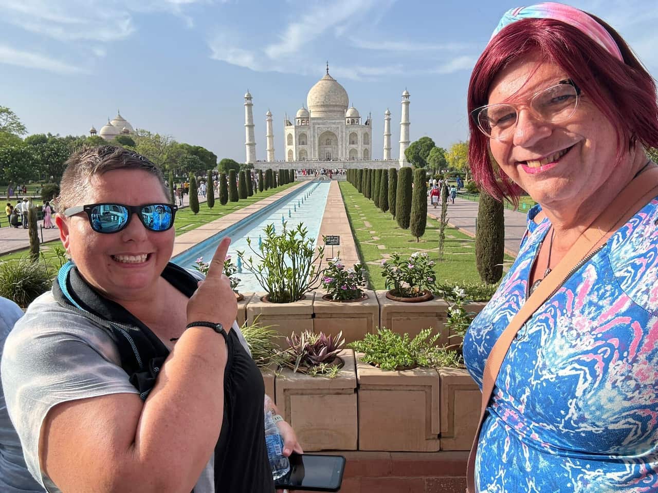 Two people pose in front of the Taj Mahal.