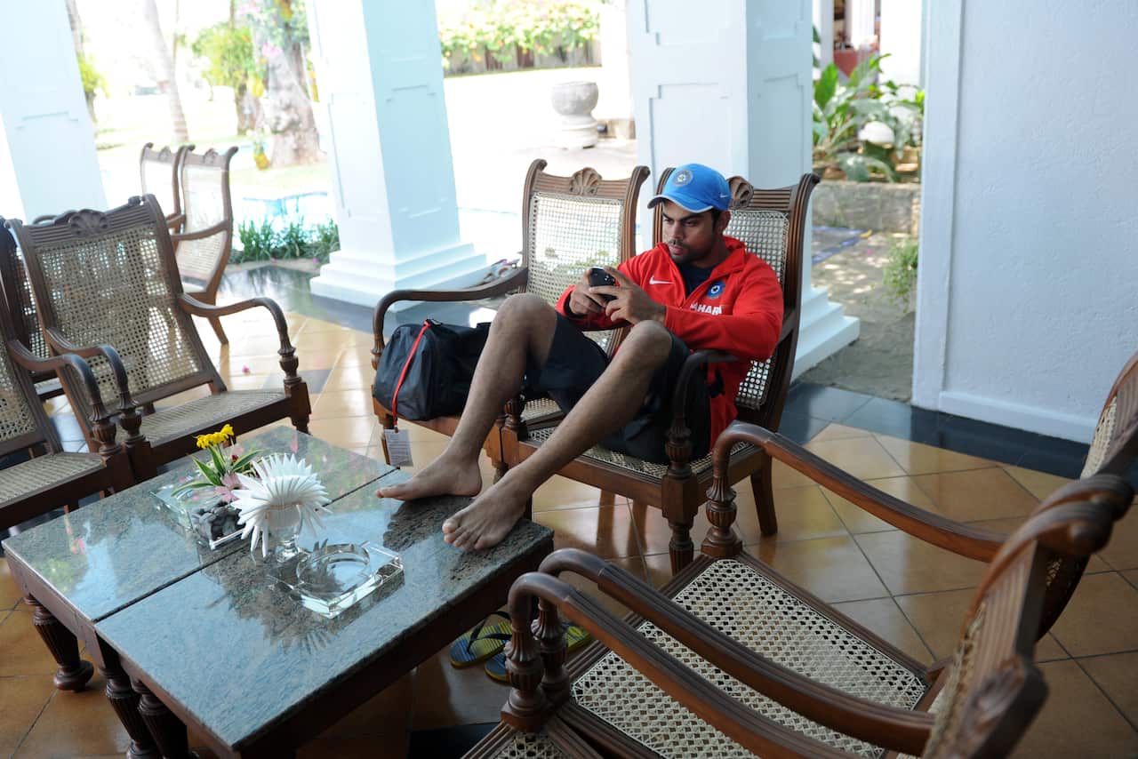 Indian cricketer Virat Kohli sits in a h