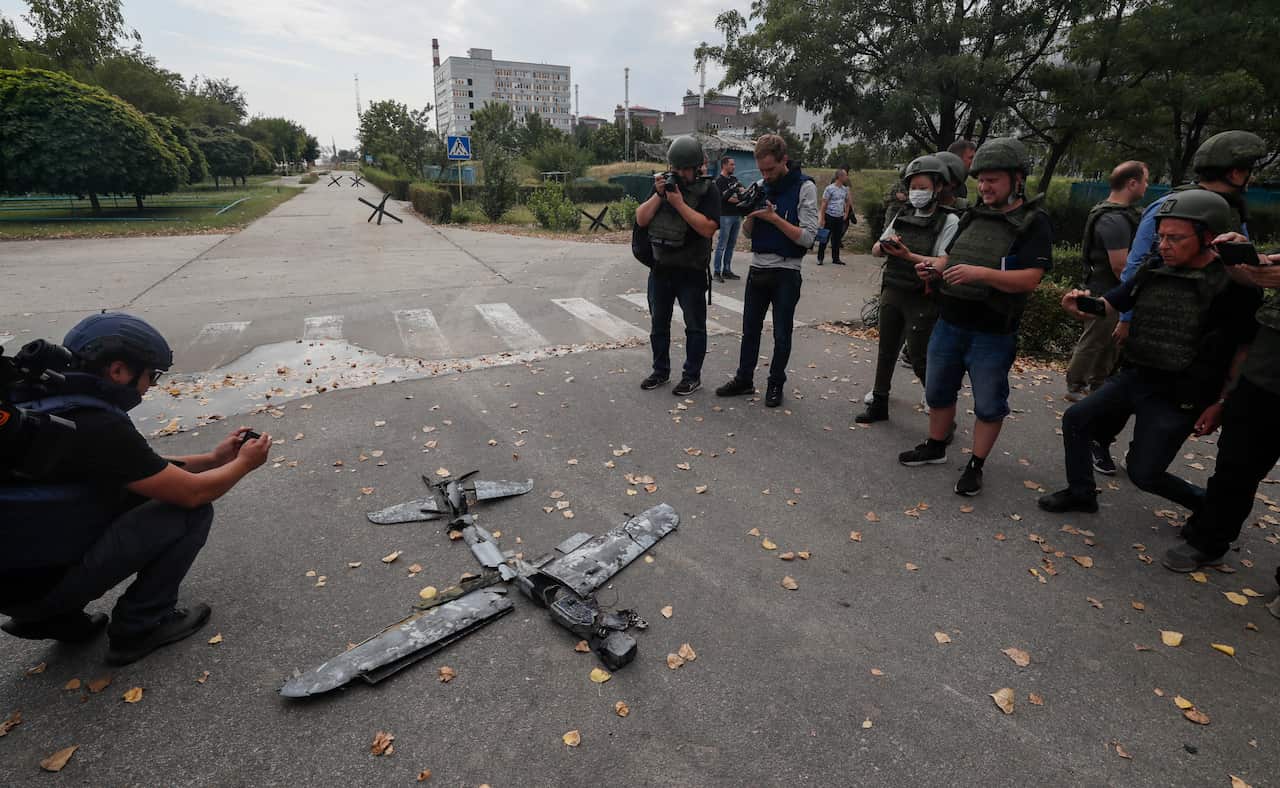 International journalists examine an unmanned aerial vehicle (UAV) on the territory of the Zaporizhzhia Nuclear Power Plant in Enerhodar, southeastern Ukraine on 1 September 2022. 