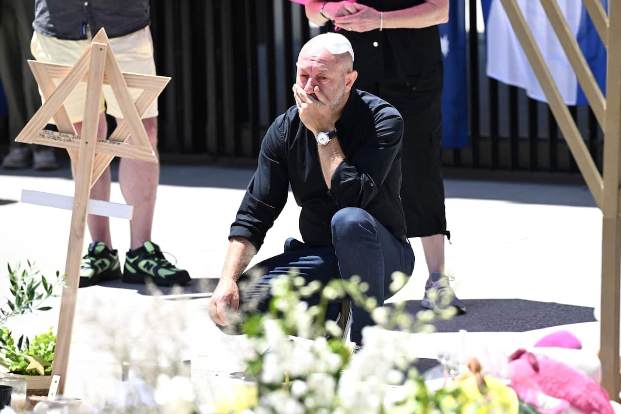 A man kneels at a memorial for the Bondi terrorist attack
