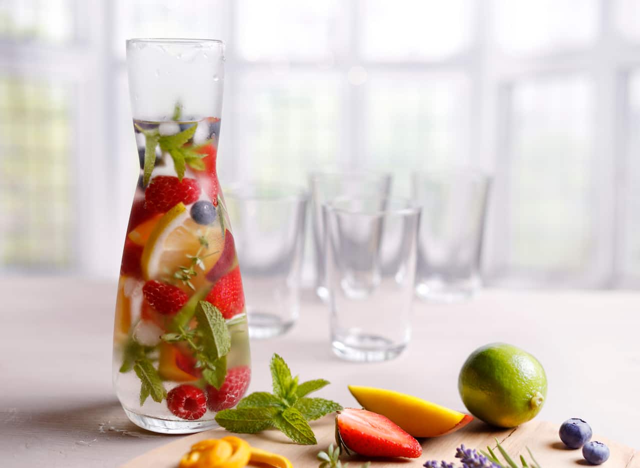 Cold infused water with colorful fruits and various herbs